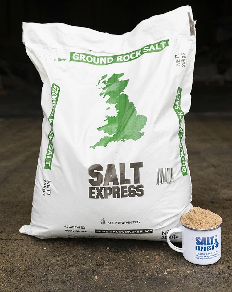 A 25kg Salt Express bag of ground rock salt beside a Salt Express mug